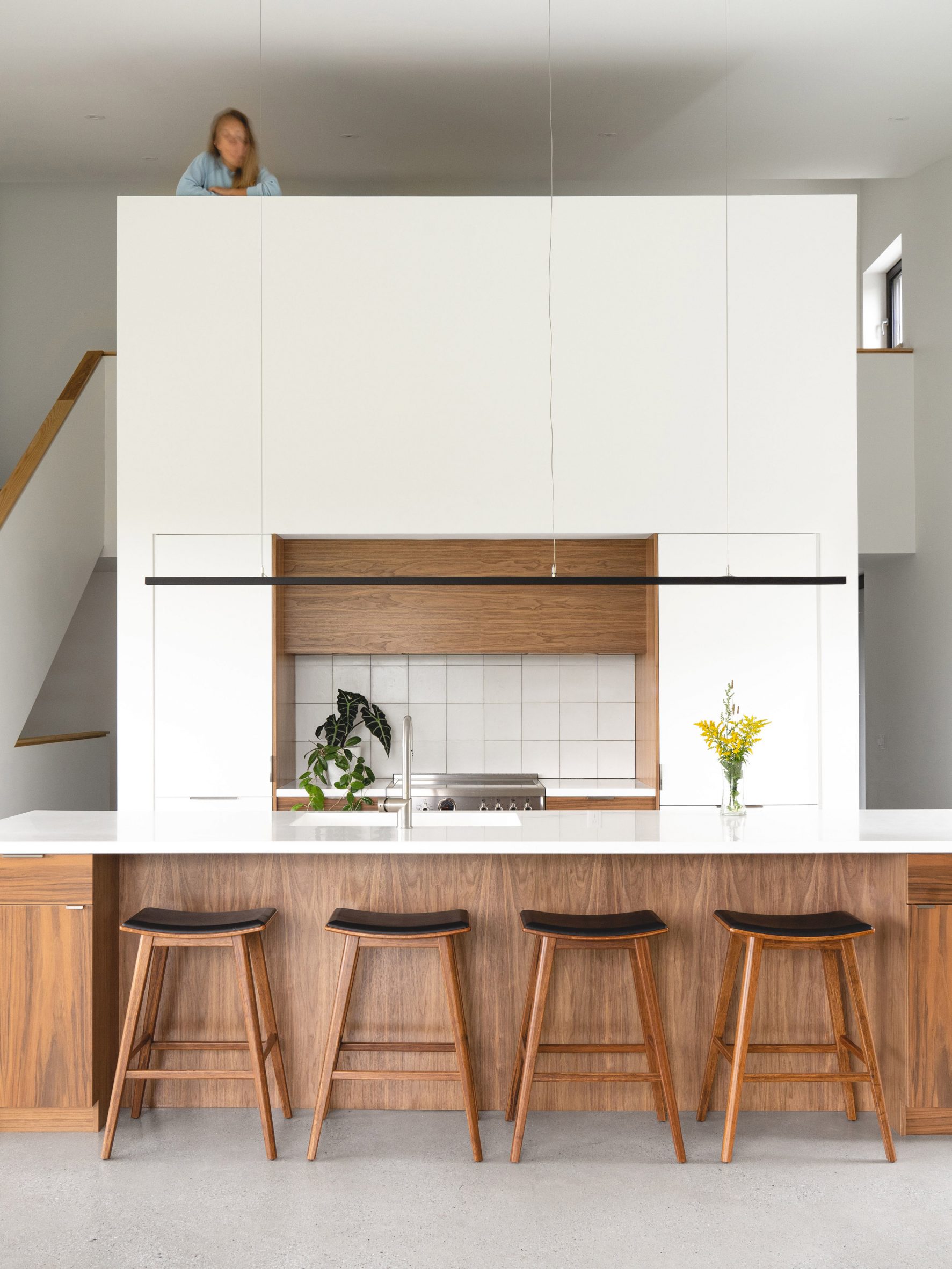 Kitchen with mezzanine space above in Saltbox Passive House