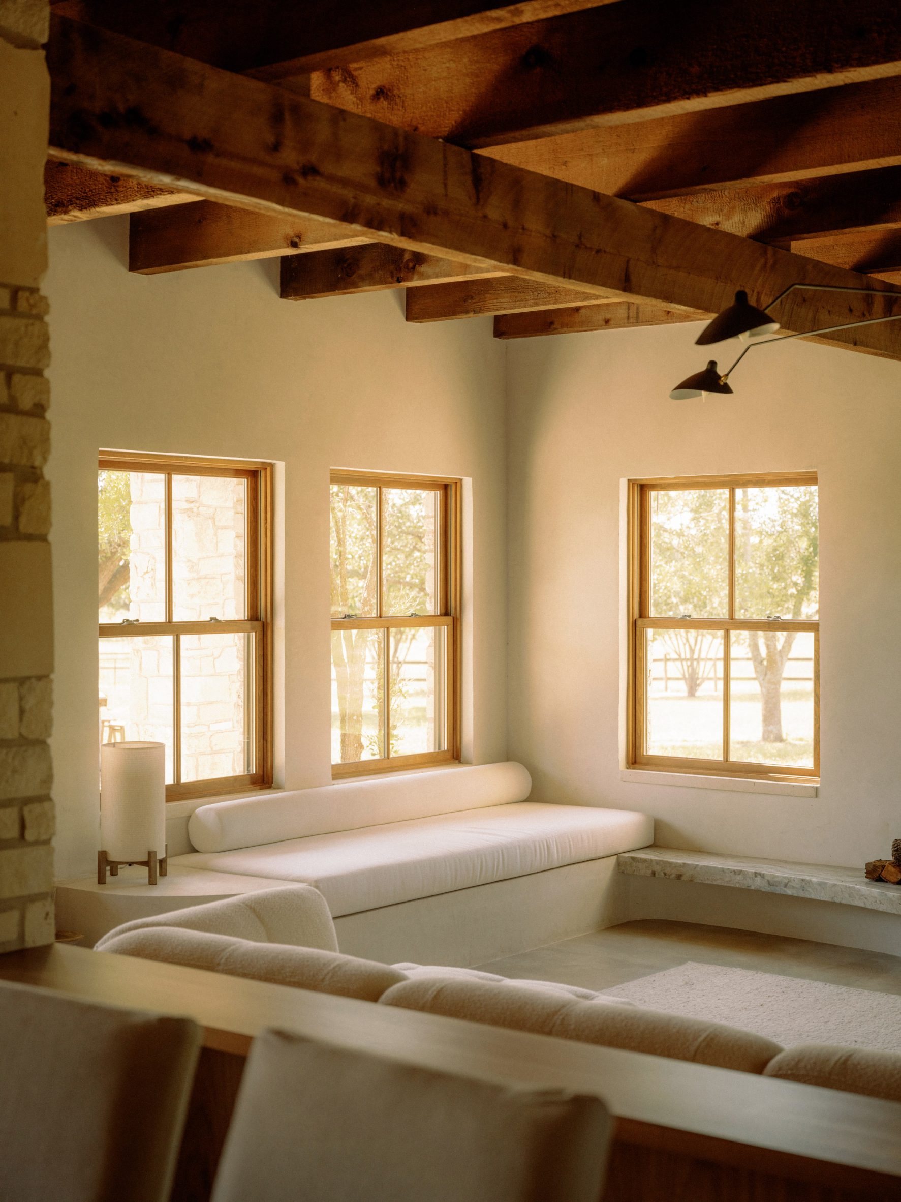 Living room with wooden ceiling beams and built-in sofas