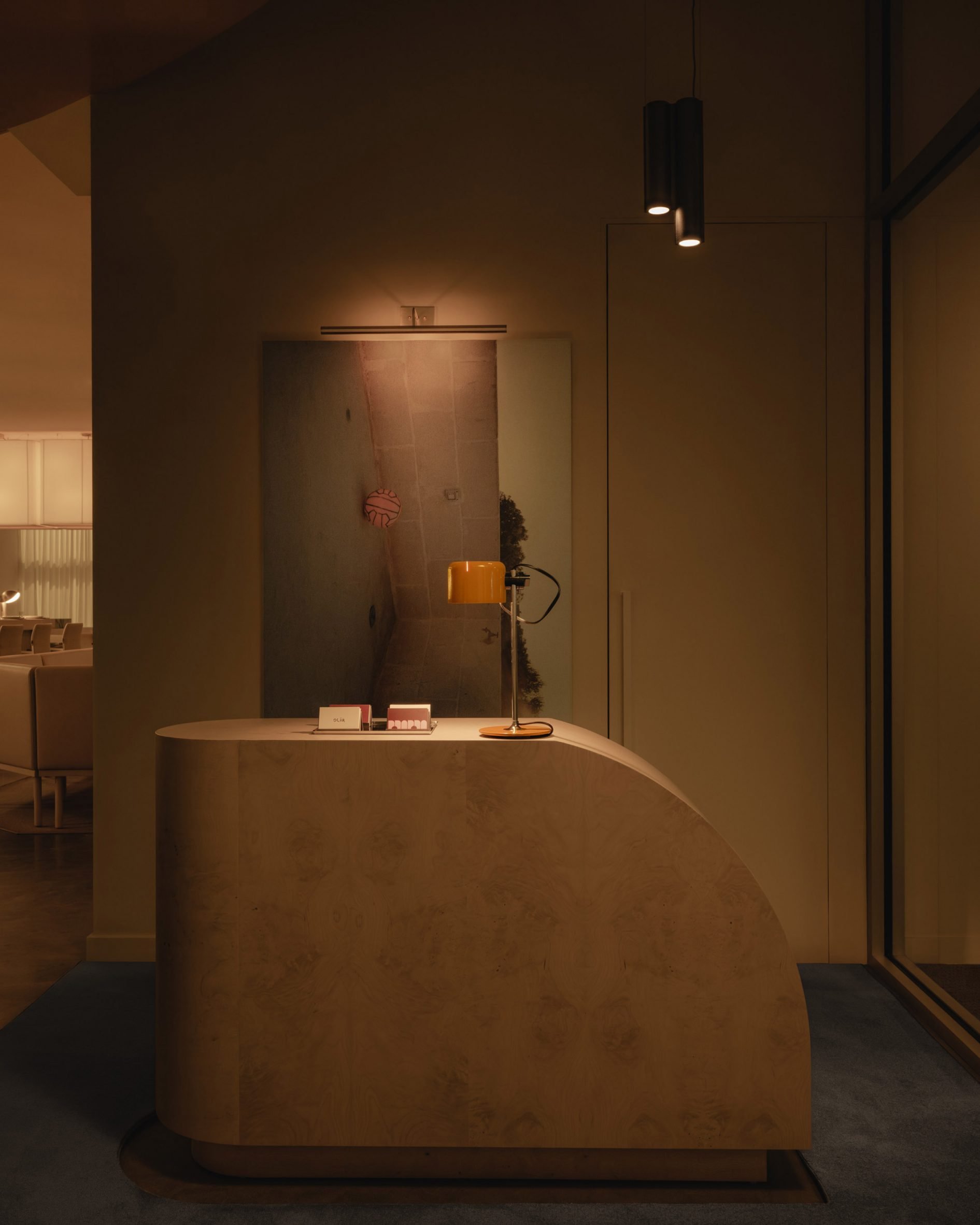 A sculptural stone host stand in a dimly lit space