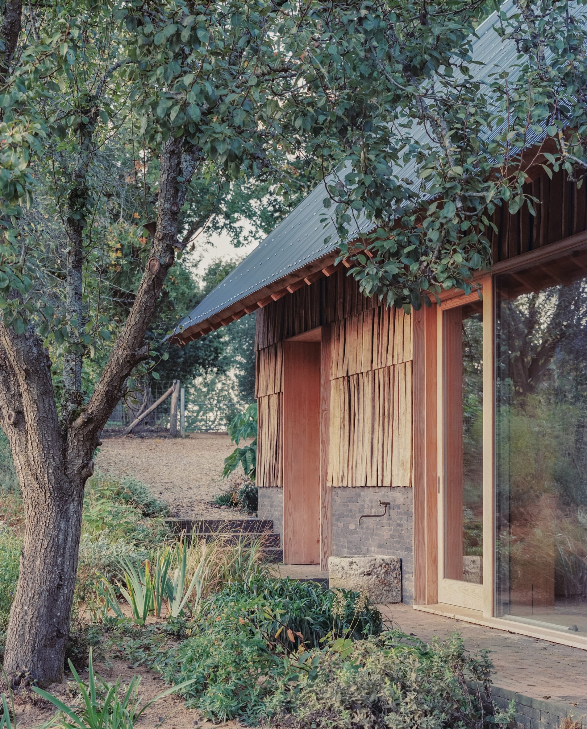 Shingle-clad exterior of education centre by Okra